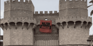 Joves de Compromís desplegan una pancarta en las Torres de Serranos contra Mazón