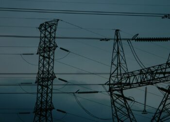 A group of power lines in the middle of the night