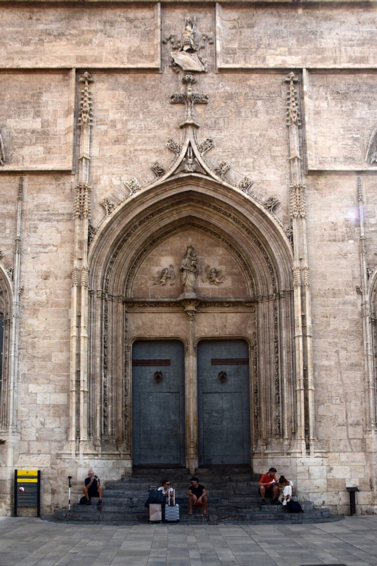 Despegan la señalética de prohibido sentarse en los escalones de la Lonja de la seda