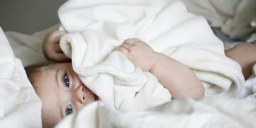 baby laying on bed