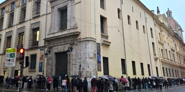 Cola de personas esperando frente a la oficina del padrón de València antes de su apertura a las 8:30 horas